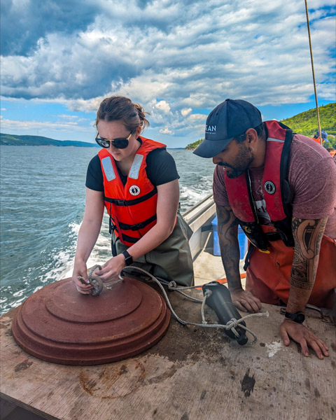 Young woman tying knots to anchors on a ship.