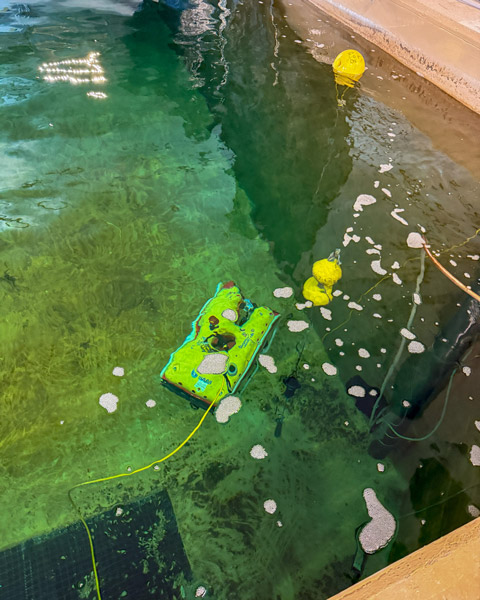 A remotely operated vehicle in a deep pool of water.