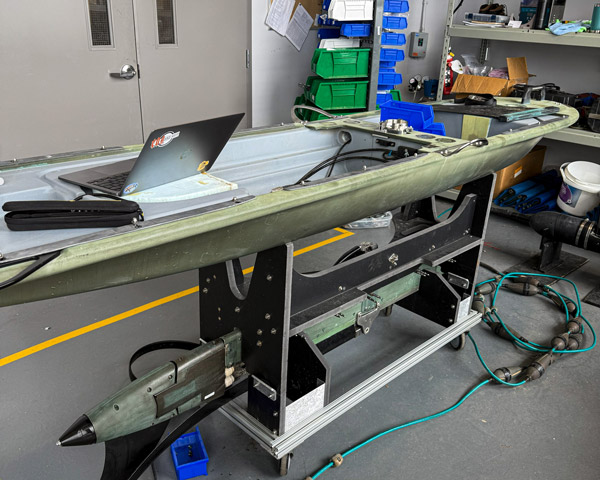 A Wave Glider open in a workshop.